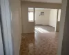 Spare room featuring an AC wall unit and a baseboard heating unit