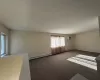 Unfurnished room featuring a baseboard heating unit, a wall mounted air conditioner, and carpet floors