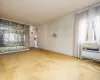 Unfurnished living room featuring carpet and ornamental molding