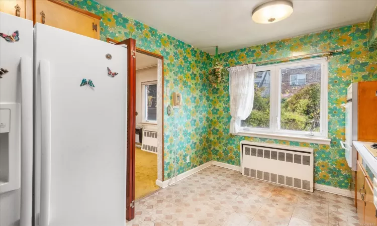 Kitchen featuring white fridge and radiator