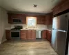 Kitchen with sink, stainless steel appliances, and light hardwood / wood-style flooring