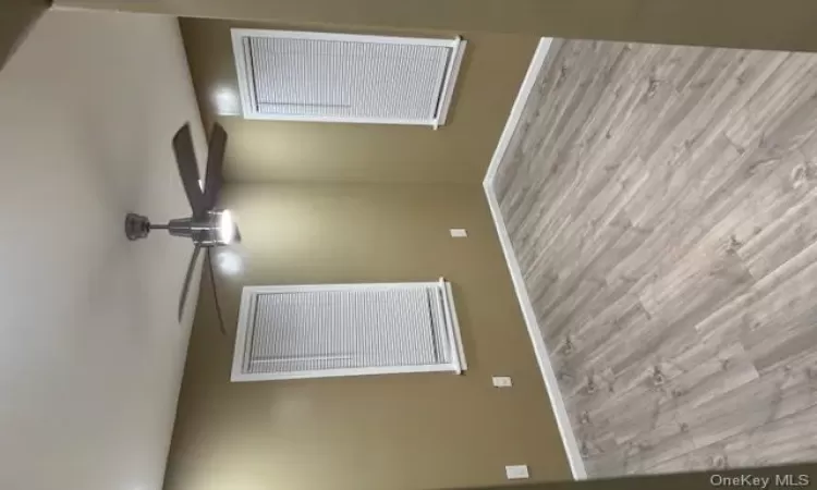 Empty room featuring light hardwood / wood-style flooring and ceiling fan