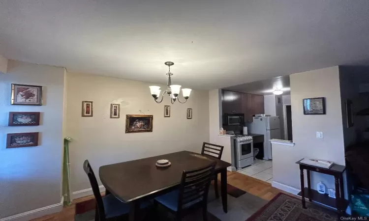 Dining room featuring light hardwood / wood-style floors and an inviting chandelier