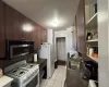 Kitchen with wooden walls, white appliances, sink, and light tile patterned floors