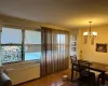 Dining area featuring a wealth of natural light, radiator heating unit, a chandelier, and hardwood / wood-style flooring