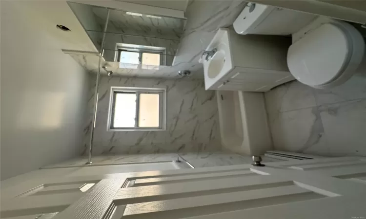 Full bathroom with vanity, toilet, and tiled shower / bath combo