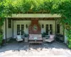 Rear patio w/ wisteria covered pergola