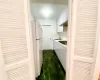 Kitchen with white cabinets, white fridge, stainless steel gas cooktop, and sink