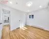 Unfurnished bedroom with light hardwood / wood-style floors and a baseboard heating unit