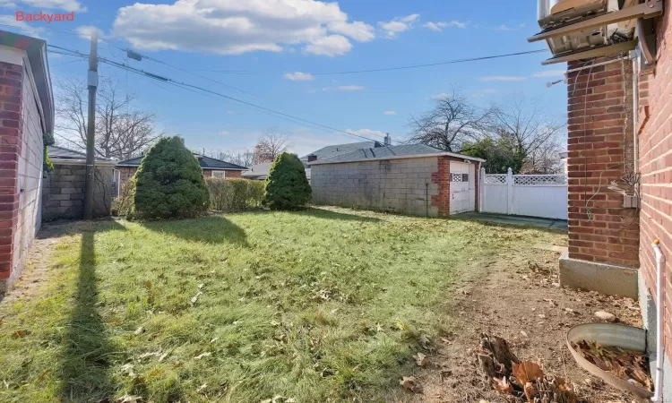 View of yard with a garage and an outdoor structure