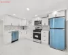 Kitchen with backsplash, sink, white cabinets, and stainless steel appliances