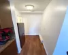 Hallway with dark hardwood / wood-style flooring and a baseboard radiator