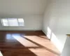 Spare room featuring hardwood / wood-style floors and a baseboard heating unit