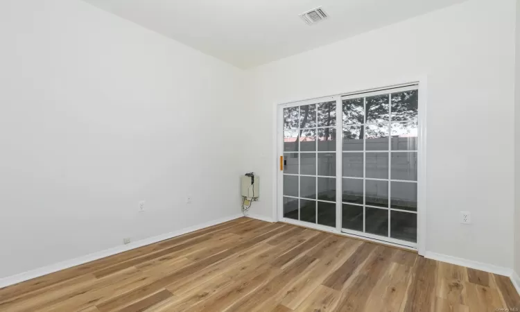 Spare room featuring wood-type flooring