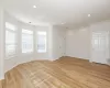 Empty room with light hardwood / wood-style floors