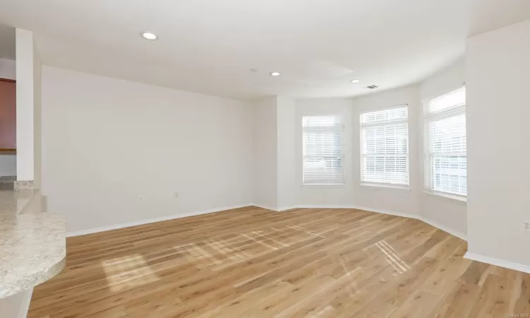 Empty room with light hardwood / wood-style floors