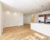 Kitchen with light stone counters, appliances with stainless steel finishes, and light hardwood / wood-style flooring