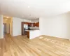 Kitchen featuring kitchen peninsula, pendant lighting, light hardwood / wood-style floors, and appliances with stainless steel finishes