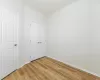 Unfurnished bedroom with light hardwood / wood-style floors and a closet