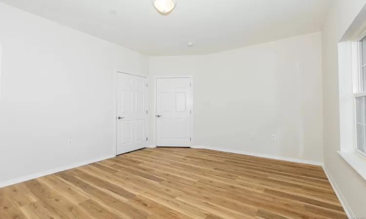 Spare room with light hardwood / wood-style floors and a healthy amount of sunlight