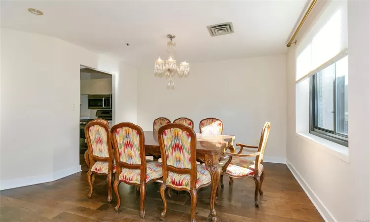 Dining room featuring a notable chandelier and dark hardwood / wood-style floors