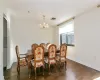 Dining area featuring a notable chandelier and dark hardwood / wood-style floors