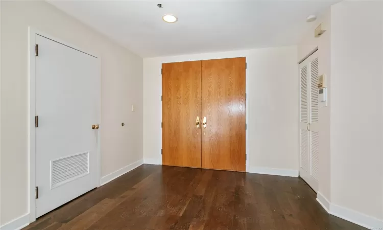 Corridor with mail boxes, a drop ceiling, and light tile patterned flooring