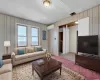 living room virtually staged with elevator in foyer