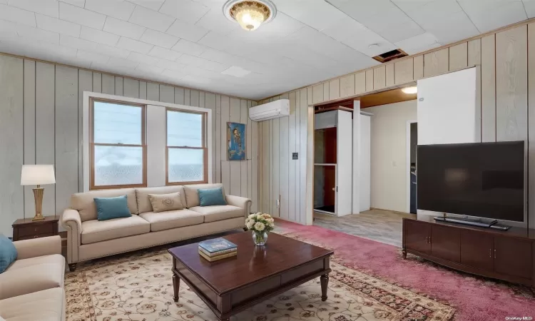 living room virtually staged with elevator in foyer