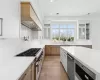 Kitchen with premium range hood, light stone counters, double oven range, light hardwood / wood-style flooring, and white cabinets