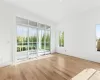 Empty room featuring light hardwood / wood-style floors and a healthy amount of sunlight