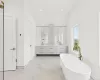 Bathroom with separate shower and tub, vanity, and lofted ceiling