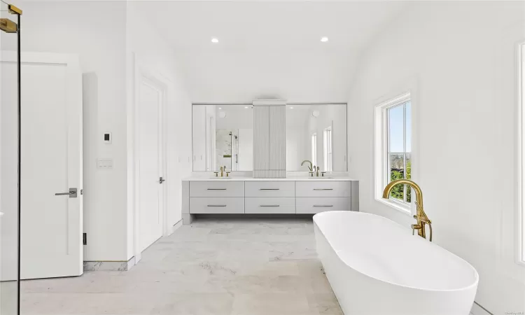 Bathroom with separate shower and tub, vanity, and lofted ceiling