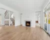 Unfurnished living room with a fireplace and light hardwood / wood-style flooring