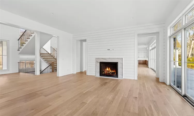 Unfurnished living room with a fireplace and light hardwood / wood-style flooring