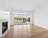 Unfurnished living room featuring light wood-type flooring and a premium fireplace