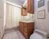 Full bathroom featuring tile patterned floors, vanity, shower / bath combo, and toilet