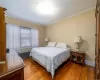 Bedroom featuring wood-type flooring and ornamental molding