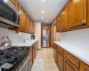 Kitchen with sink, light tile patterned floors, and appliances with stainless steel finishes