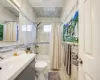 Full bathroom featuring vanity, toilet, tile walls, and shower / tub combo