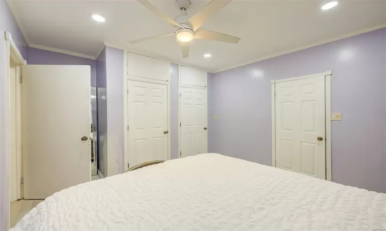 Bedroom featuring ceiling fan and crown molding