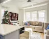 Living room with an AC wall unit, ceiling fan, lofted ceiling, and light wood-type flooring