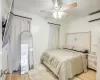 Bedroom featuring a wall unit AC, ceiling fan, and light hardwood / wood-style flooring