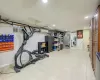 Exercise area featuring light tile patterned floors and a wall unit AC