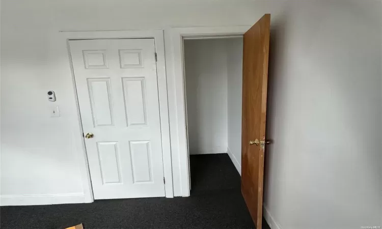 Basement with hardwood / wood-style floors and a textured ceiling