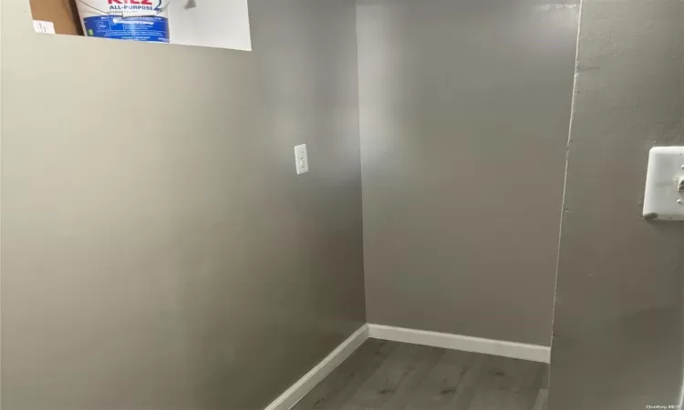 Kitchen featuring sink, radiator heating unit, stainless steel appliances, light stone counters, and decorative backsplash