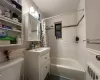 Full bathroom with toilet, shower / bath combo, wood-type flooring, vanity, and radiator heating unit