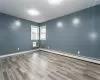 Spare room with light wood-type flooring and a baseboard heating unit