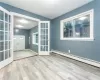 Foyer entrance featuring light hardwood / wood-style flooring, a baseboard radiator, and french doors