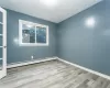 Spare room featuring light hardwood / wood-style flooring and a baseboard heating unit